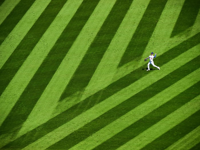 Cody Bellinger throwing on grass